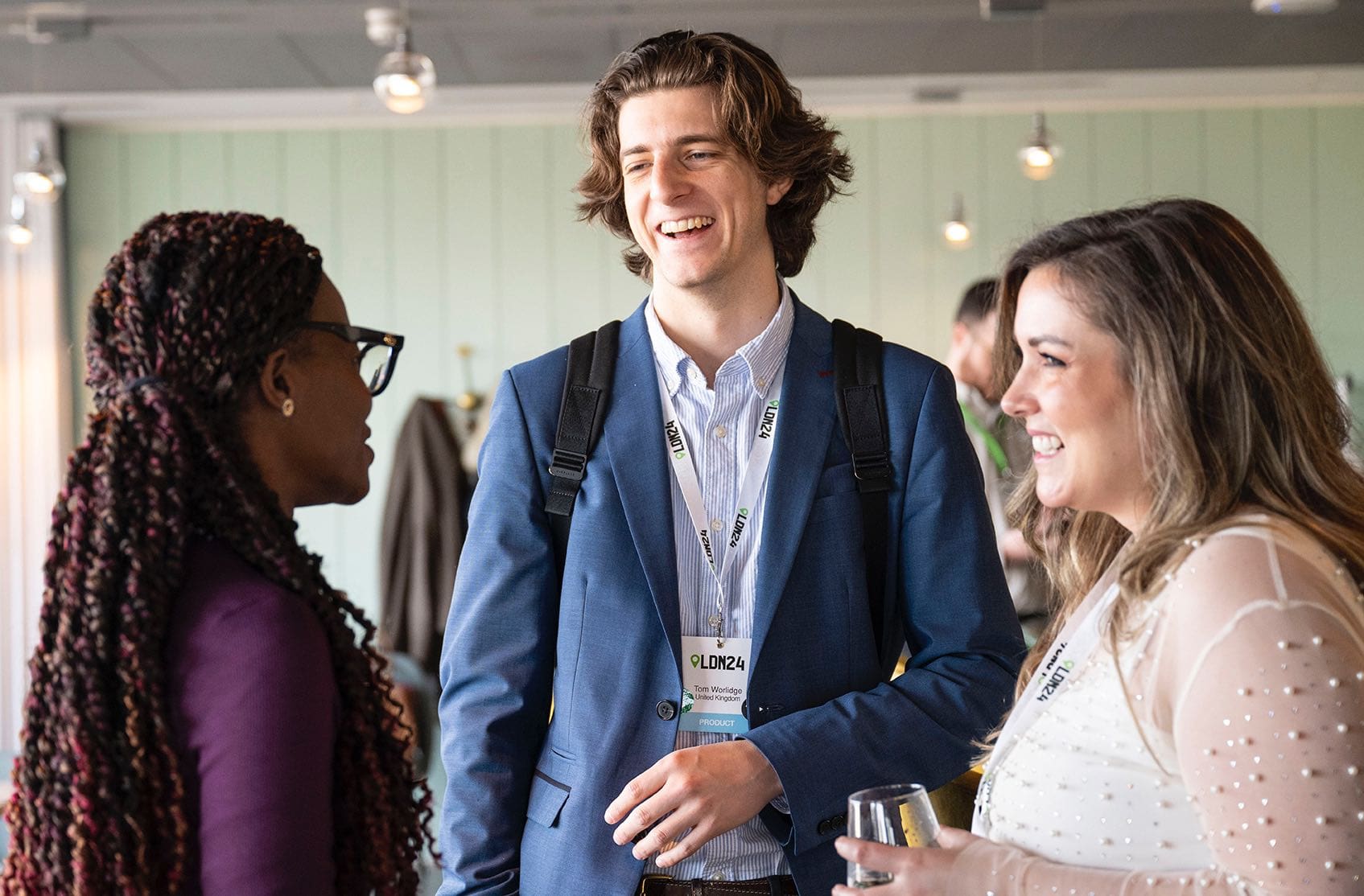 Three Expana employees talking looking hapy