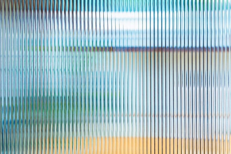 Texture of wavy glass illuminated with multi-colored light