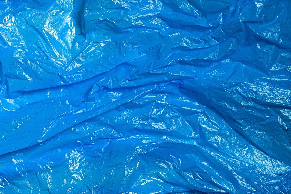 Wrinkled blue plastic texture representing packaging material