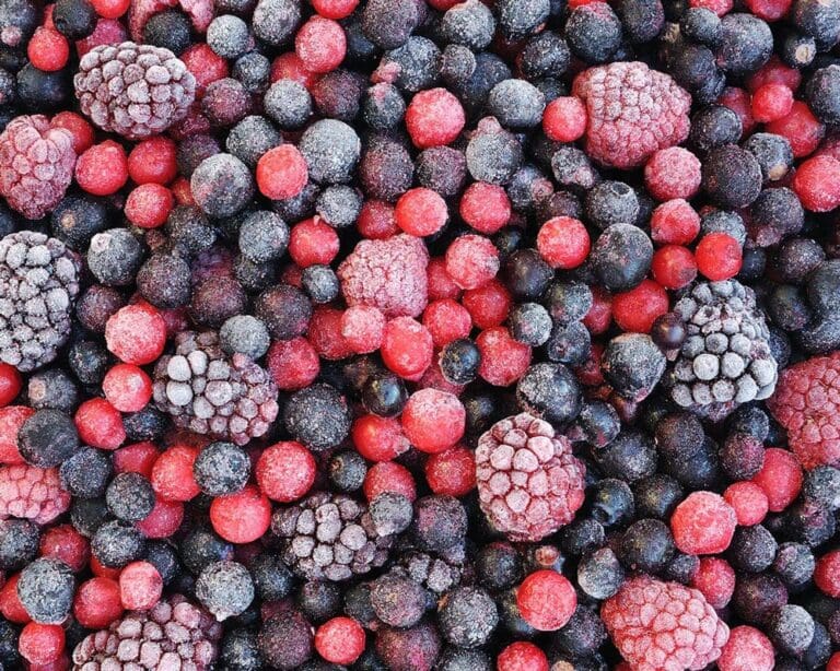 Close up of frozen mixed fruit - berries - red currant, cranberry, raspberry, blackberry, bilberry, blueberry, black currant