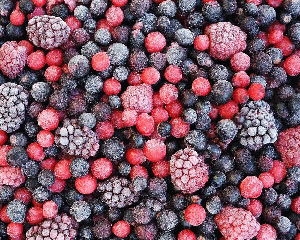 Close up of frozen mixed fruit - berries - red currant, cranberry, raspberry, blackberry, bilberry, blueberry, black currant