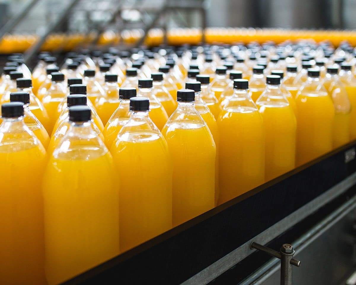Orange juice bottling line in a factory
